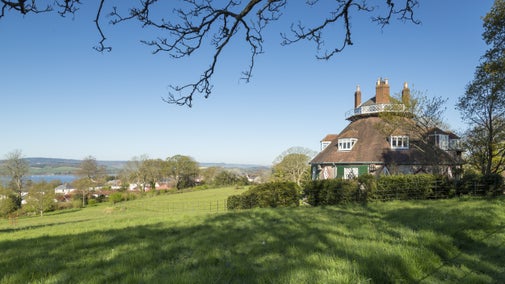 Autumnal view of A la Ronde house on a hilltop overlooking the Exe estuary
